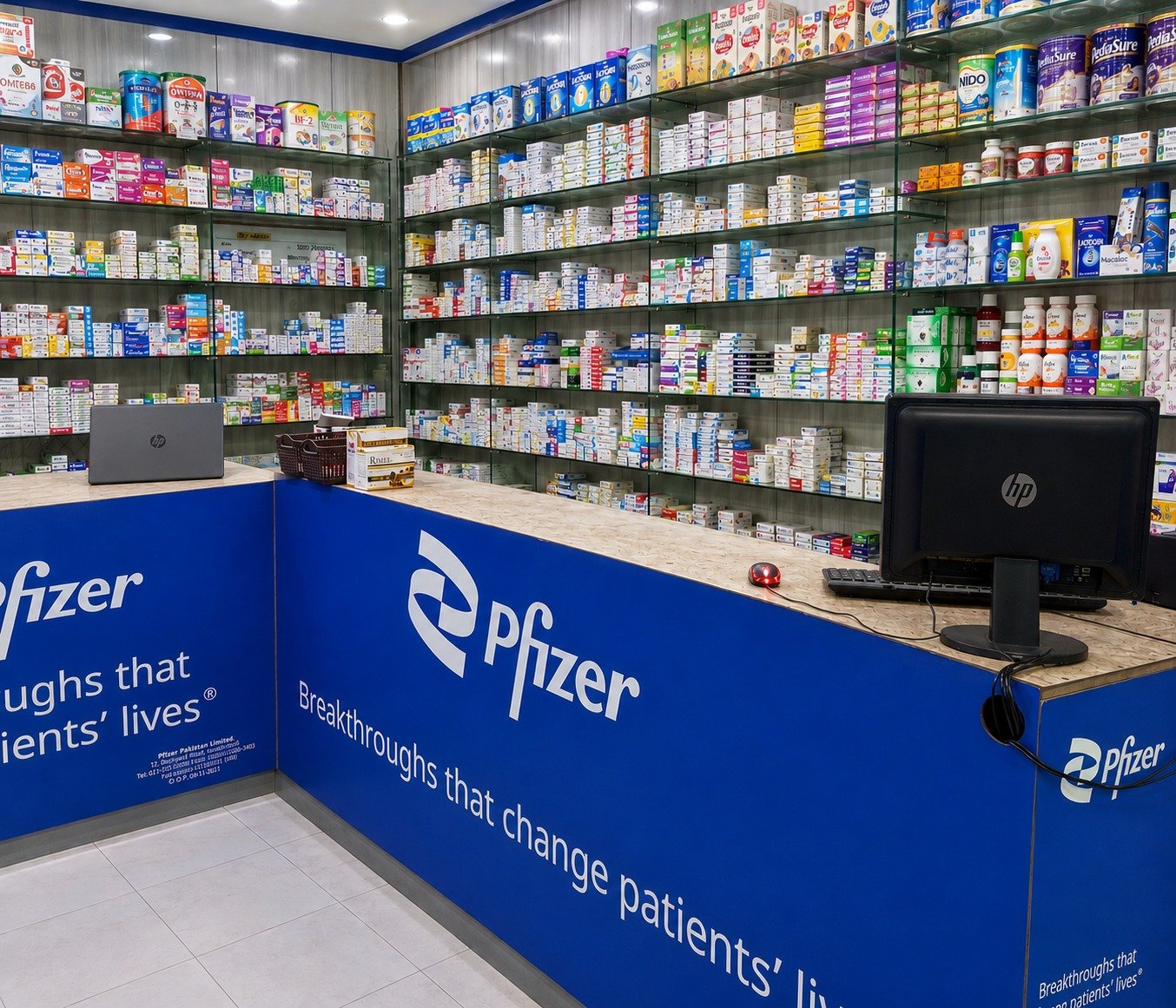 Pharmacist arranging medicine shelves
